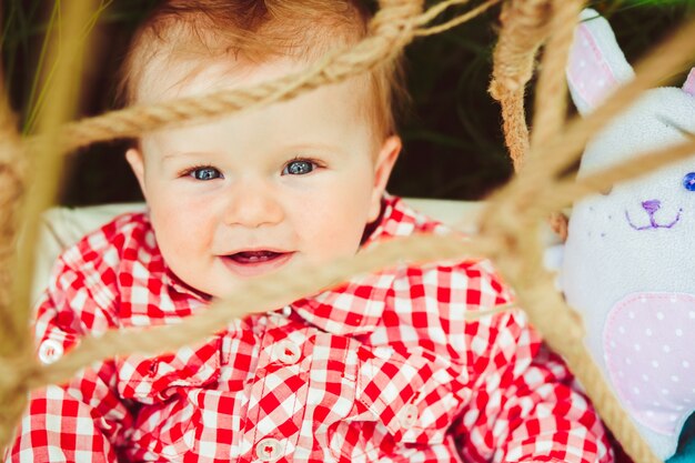 Baby seen through ropes