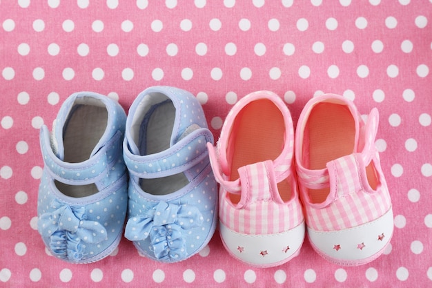 Baby shoes on cloth background