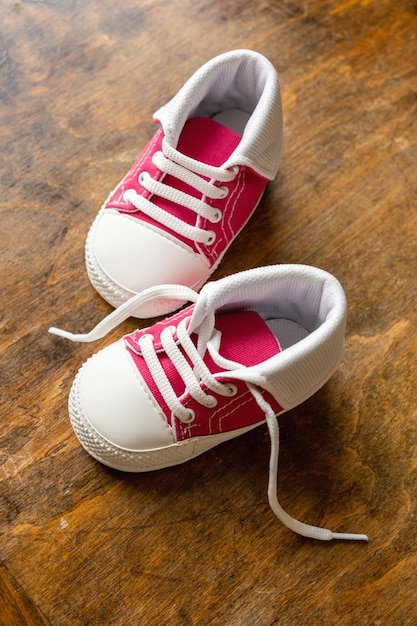 Baby shoes on wood closeup above view