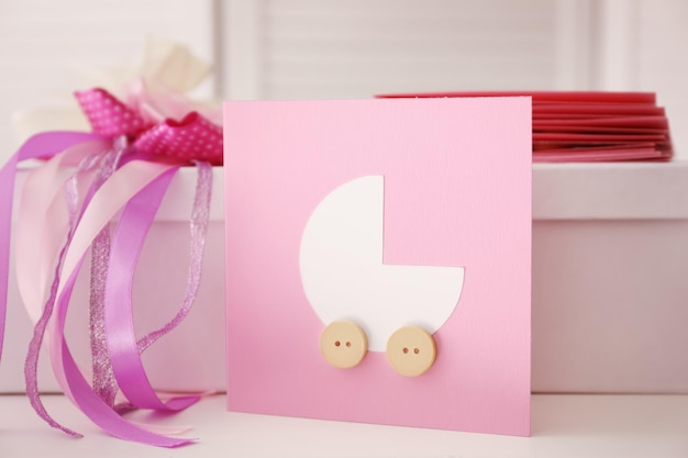 Baby shower thank you card and box on table