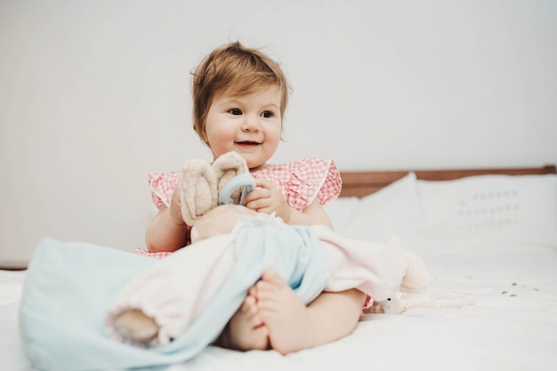 Baby sitting on a bed