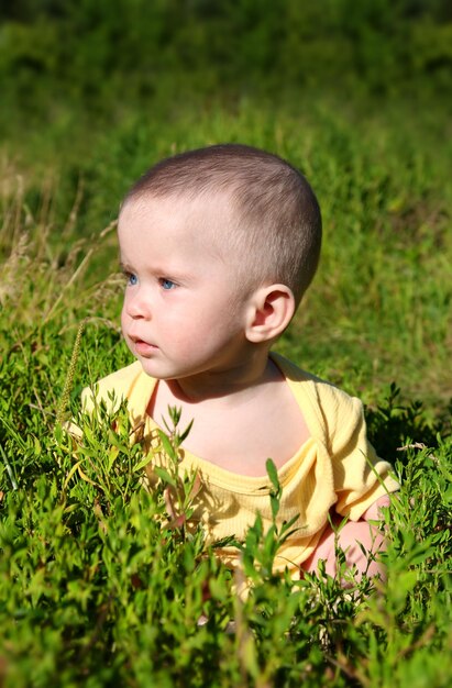 Baby sitting in grass