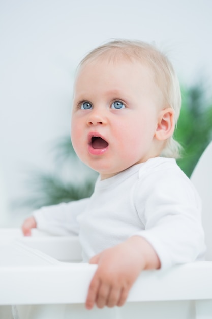 Baby sitting on a high chair