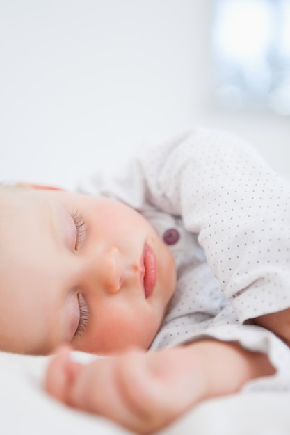 Baby sleeping while extending her arm