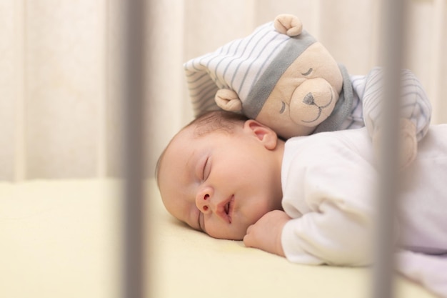 The baby sleeps in the copy space crib Advertising of children's goods Illustrating children's articles A small child A newborn