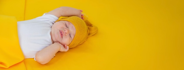 baby sleeps on a yellow background child