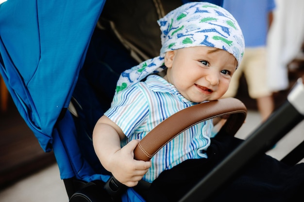 Baby in a stroller with a brown handle