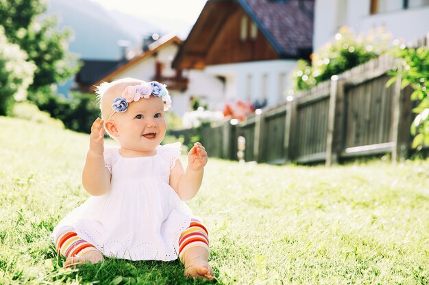 Baby at summer outside little girl on green nature happy child have fun on grass of meadow