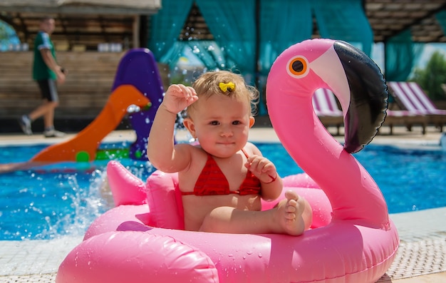 Photo baby swims in a circle in the pool. selective focus. child.