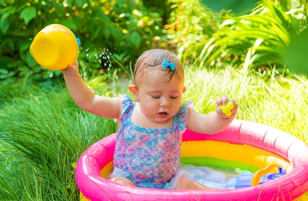 Baby swims in the pool. Selective focus. Child.