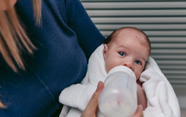 Baby taking feeding bottle