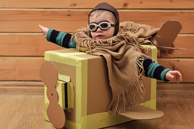 Photo baby in toy plane. kids adventure. children at home or daycare.