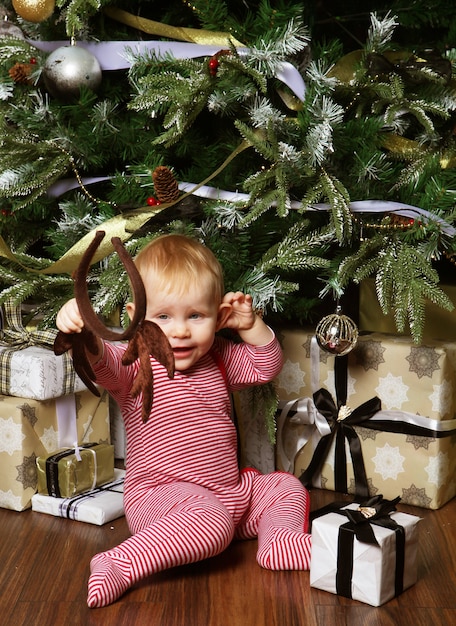 Baby with christmas decoration. Happy New Year!