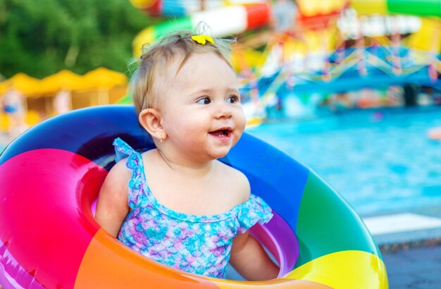 Baby with a circle near the pool. Selective focus.