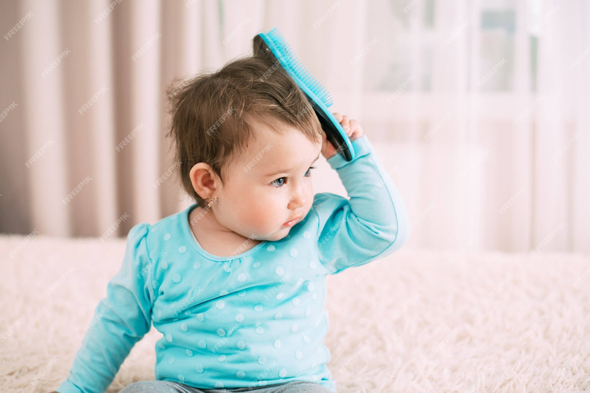 Premium Photo | Baby with a comb a little girl with a blue comb comb combs her hair Premium Photo | Baby with a comb a little girl with a blue comb comb combs her hair