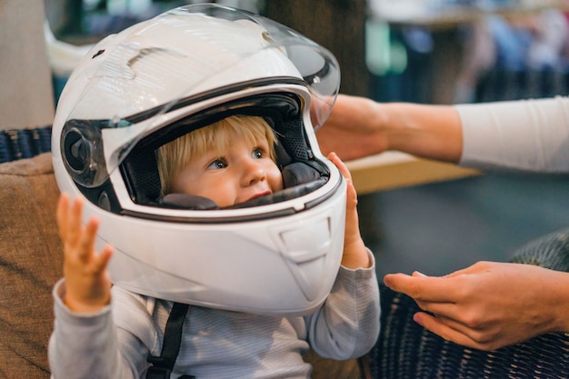 Baby with a motorbike helmet