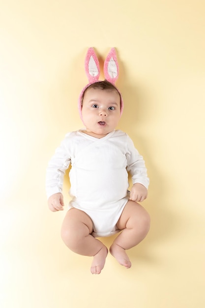 Baby with rabbit ears in an Easter egg Concept the inscription of Happy Easter Mockup for advertising design celebration postcards