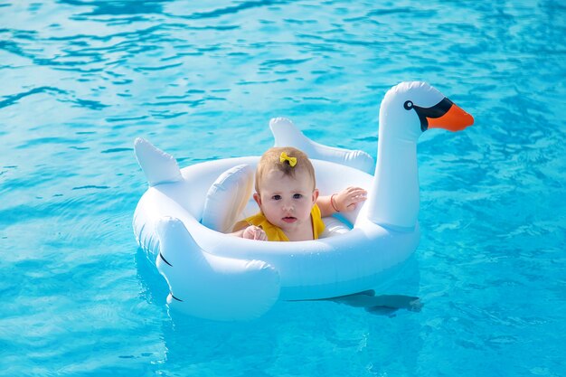 Baby zwemt in een rubberen ring op zee