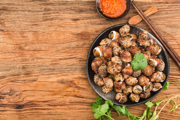 Babylonia areolata shellfish seafood on bowl ready for eat or cooked