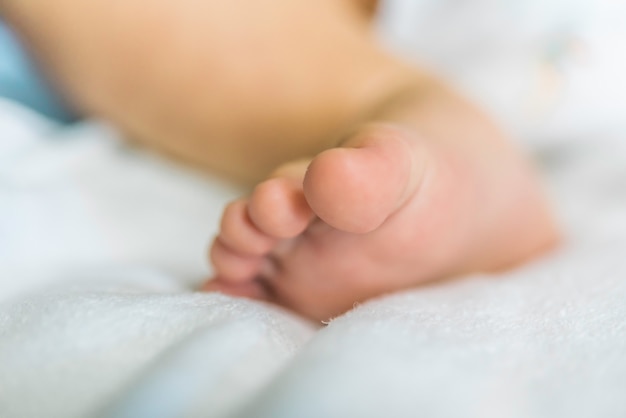 babys feet are on the couch.