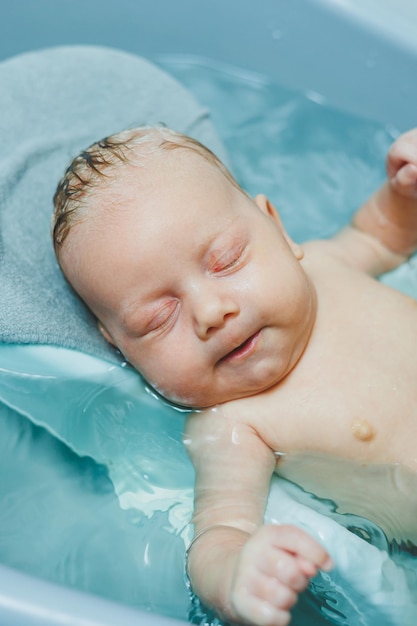 Babys first baths Caring for a newborn baby Bathing a baby in a bathtub