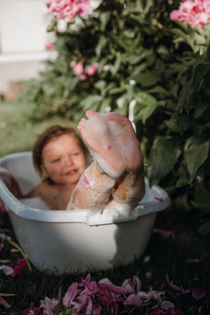 Photo babys heels in bubble bath closeup