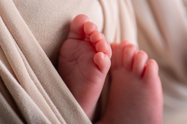 a babys toes are visible on the back of a blanket