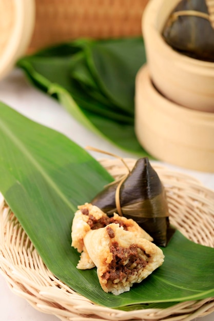 Bacang or bakcang is a snack from China made of rice or glutinous rice with various fillings and wrapped in bamboo leaves