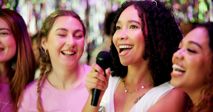 Photo bachelorette party karaoke and singing with women at club for bride to be wedding and night out music bridal shower and hen do with people and microphone for social event friends and happiness