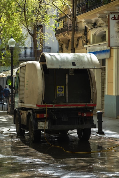 Back of a cleaning truck from the municipal service brigade cleaning a pedestrian street