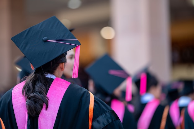 The back of the graduates are walking to attend the graduation ceremony at the university	