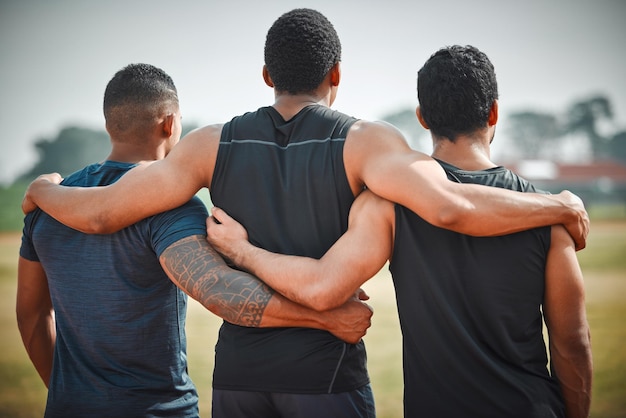 Back group hug and athlete men with teamwork outdoor for running sports or workout Collaboration hugging and rear view of people friends and runners for fitness support and exercise together