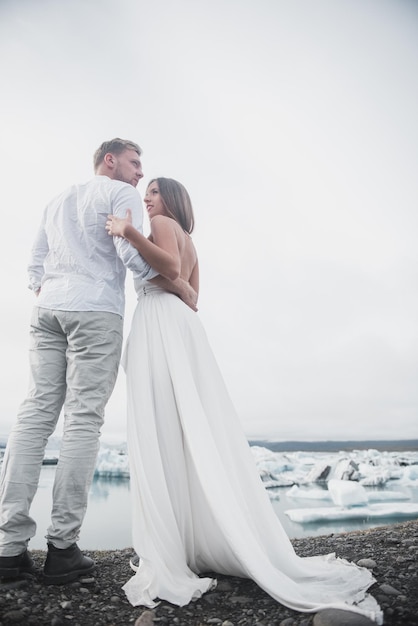 Back of just married couple taking walk on plains of Iceland