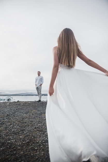 Back of just married couple taking walk on plains of Iceland