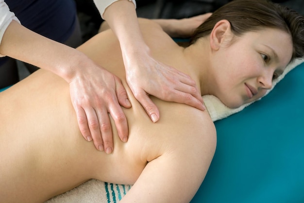 Back massage with oil for a young girl