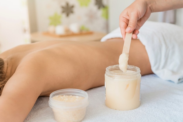 back massage for a young woman in a spa salon, scrub the skin of the body