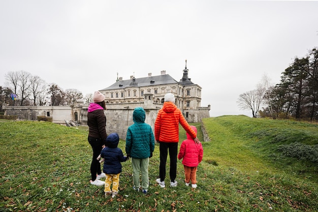 Back of mother with four kids visit Pidhirtsi Castle Lviv region Ukraine Family tourist