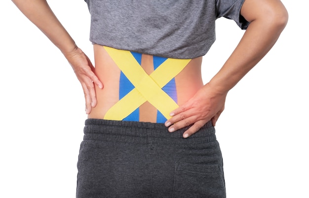 Back pain, kinesiology taping on woman back on white background with clipping path.
