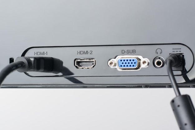 Back pannel of the monitor with different ports HDMI and power cables are plugged