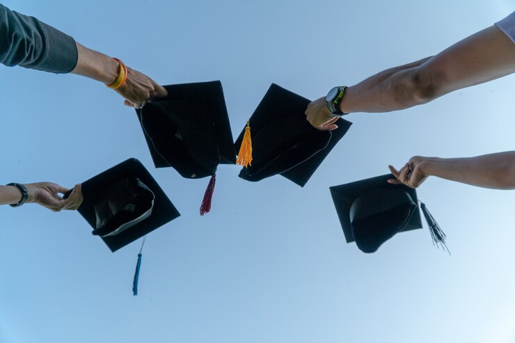 Back portrait of graduated wearing a black hat.