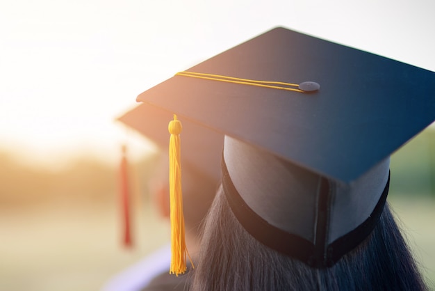 Back portrait of graduated wearing a black hat.