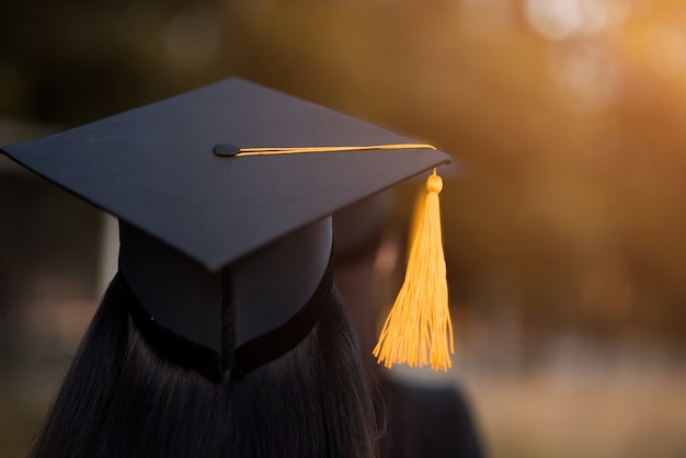 Back portrait of graduated wearing a black hat.