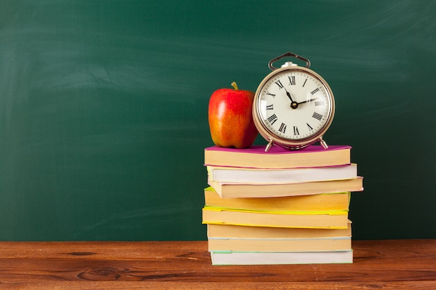 Back to school - apple and books with pencils and blackboard