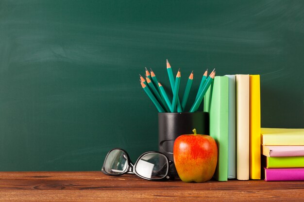 Back to school, apple and books with pencils and