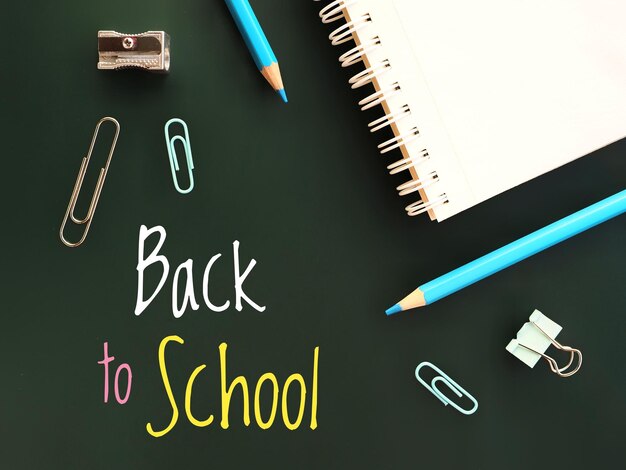 Back to school background with handwritten text Notebook and supplies