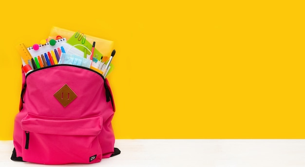 Back to school Backpack for school with bright colorful office supplies and medical mask