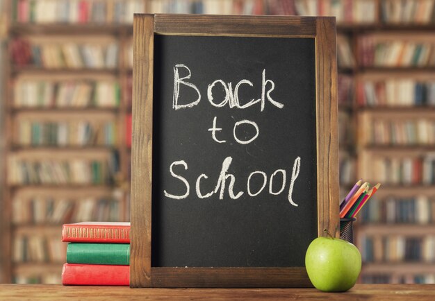 Back to school. Chalk board, books and pencils