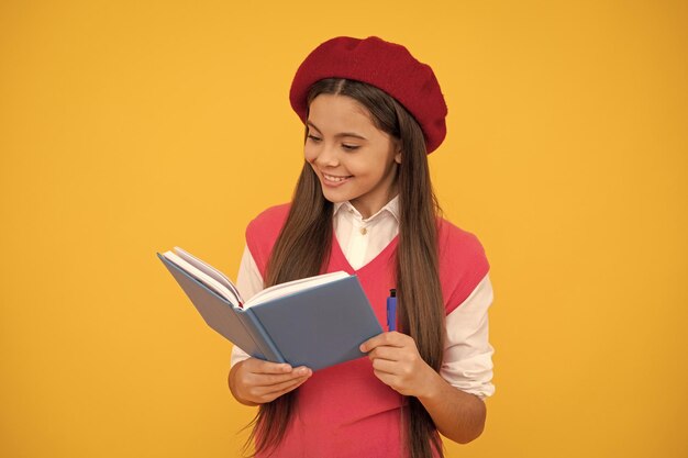 Back to school cheerful kid in beret ready to study smiling child making notes teenage student