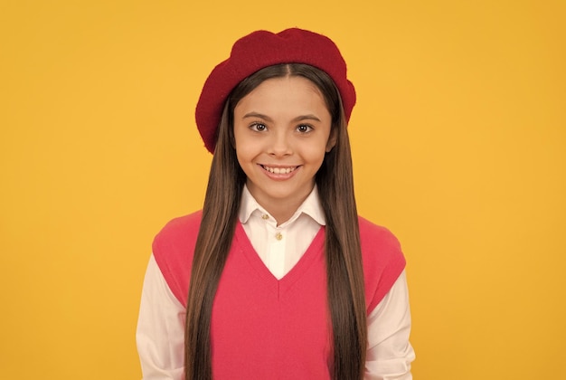 Back to school cheerful kid in beret smiling child has long hair skin beauty