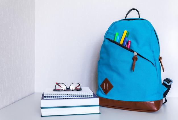 Back to school concept. Backpack with school supplies. Copy space